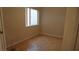 Bright bedroom featuring parquet floors and natural light from the window at 8052 Marbella Cir, Las Vegas, NV 89128
