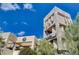 Exterior building view with striking architectural details and lush greenery at 8052 Marbella Cir, Las Vegas, NV 89128