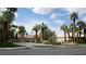 A gated community with mature landscaping and lush green grass and palms at 8052 Marbella Cir, Las Vegas, NV 89128