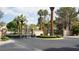 Automated gate to a neighborhood with mature landscaping and lush green grass at 8052 Marbella Cir, Las Vegas, NV 89128