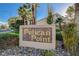 A welcoming entrance to the Pelican Point community featuring a stone sign surrounded by lush greenery and rocks at 8052 Marbella Cir, Las Vegas, NV 89128