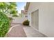 Exterior patio view of a home with tiled access, complemented by desert-friendly landscaping at 8052 Marbella Cir, Las Vegas, NV 89128