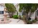 Front entrance adorned with mature landscaping, offering privacy and curb appeal at 8052 Marbella Cir, Las Vegas, NV 89128
