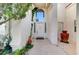 Inviting front entrance showcasing a decorative front door, potted plants, and a textured walkway at 8052 Marbella Cir, Las Vegas, NV 89128