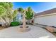 Charming front yard featuring a decorative fountain, mature trees, and a well-manicured landscape at 8052 Marbella Cir, Las Vegas, NV 89128