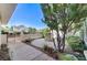 Charming front yard featuring a decorative fountain, mature trees, and a well-manicured landscape at 8052 Marbella Cir, Las Vegas, NV 89128