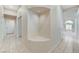 Hallway featuring unique architectural niche, and tiled floors throughout at 8052 Marbella Cir, Las Vegas, NV 89128