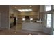 Open kitchen featuring spacious counters, ample cabinet space, black appliances, and large window for a light and airy feel at 8052 Marbella Cir, Las Vegas, NV 89128