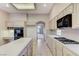 Spacious kitchen features tile countertops, a gas range, a built-in oven and microwave, and ample cabinet space at 8052 Marbella Cir, Las Vegas, NV 89128