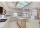 Bright kitchen boasts tile floors, an island, sink, gas range, a window, and access to the living areas at 8052 Marbella Cir, Las Vegas, NV 89128