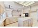 Open kitchen boasts tile countertops, an island, cabinets, an oven, and views into other living spaces at 8052 Marbella Cir, Las Vegas, NV 89128