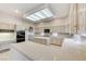 Spacious kitchen featuring tile floors, a center island, and ample cabinetry for storage at 8052 Marbella Cir, Las Vegas, NV 89128