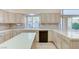 Bright kitchen featuring tile countertops, sink, dishwasher, cabinets, and an island for meal preparation at 8052 Marbella Cir, Las Vegas, NV 89128