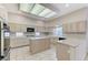 Well-lit kitchen features tile floors, center island, and plenty of counter space for cooking at 8052 Marbella Cir, Las Vegas, NV 89128