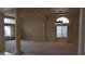 Living room with carpet flooring, large windows, and an elegant chandelier at 8052 Marbella Cir, Las Vegas, NV 89128