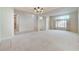 Spacious living room featuring a chandelier, large window and open access to other rooms at 8052 Marbella Cir, Las Vegas, NV 89128