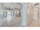 Open-concept living area with tile flooring, ceiling fans, and access to the backyard through sliding glass doors at 8052 Marbella Cir, Las Vegas, NV 89128
