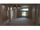 Bright living room with neutral carpet, chandelier and elegant columns in a spacious layout at 8052 Marbella Cir, Las Vegas, NV 89128