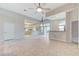 Bright open living room with tile flooring, ceiling fans, and sliding glass doors to outdoor space at 8052 Marbella Cir, Las Vegas, NV 89128