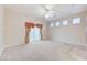 Living room featuring a ceiling fan, sliding doors, and carpet flooring throughout at 8052 Marbella Cir, Las Vegas, NV 89128