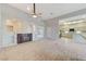 Spacious living room featuring a cozy fireplace, tile floors, and seamless flow to the adjacent kitchen at 8052 Marbella Cir, Las Vegas, NV 89128