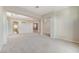 Spacious living room showcasing pillars, an elegant chandelier, and an open floor plan leading to the kitchen at 8052 Marbella Cir, Las Vegas, NV 89128