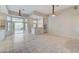 Open-concept living area with tile flooring, ceiling fans, and access to the backyard through sliding glass doors at 8052 Marbella Cir, Las Vegas, NV 89128