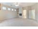 Living room showcasing a fireplace and a ceiling fan, carpeted floors, and lots of natural light at 8052 Marbella Cir, Las Vegas, NV 89128