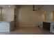 Open living area with tile flooring, a ceiling fan, and built-in fireplace at 8052 Marbella Cir, Las Vegas, NV 89128