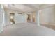 Spacious living room showcasing pillars, an elegant chandelier, and an open floor plan leading to the kitchen at 8052 Marbella Cir, Las Vegas, NV 89128