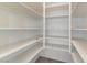 Walk-in pantry with multiple shelves for storage of food and kitchen appliances at 8052 Marbella Cir, Las Vegas, NV 89128