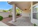 A covered patio with tiled flooring and a ceiling fan offers outdoor space for relaxation and entertaining at 8052 Marbella Cir, Las Vegas, NV 89128