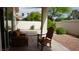 Cozy outdoor patio featuring seating and lush landscaping at 8052 Marbella Cir, Las Vegas, NV 89128