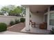 Covered patio with decorative stone tiles and desert landscaping at 8052 Marbella Cir, Las Vegas, NV 89128