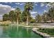 Scenic pond featuring lush greenery, ducks, and mature palm trees in a serene setting at 8052 Marbella Cir, Las Vegas, NV 89128