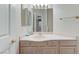 Powder room with neutral colors, featuring a single vanity and framed mirror at 8052 Marbella Cir, Las Vegas, NV 89128