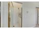 Tiled shower with glass door and accessible handrails at 8052 Marbella Cir, Las Vegas, NV 89128