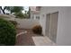 Low maintenance side yard with gravel and flowering bushes at 8052 Marbella Cir, Las Vegas, NV 89128