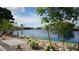 Picturesque lake view featuring a bridge, lush landscaping, and serene waters at 8052 Marbella Cir, Las Vegas, NV 89128