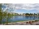 Scenic waterfront view of community lake, landscaping, and adjacent homes at 8052 Marbella Cir, Las Vegas, NV 89128