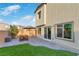 Inviting backyard featuring a patio area with outdoor seating, artificial grass, and a well-maintained exterior at 816 Sand Camel Ct, North Las Vegas, NV 89081