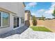 Landscaped backyard with pavers, artificial grass, and views of adjacent homes at 816 Sand Camel Ct, North Las Vegas, NV 89081
