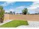 Fenced backyard featuring artificial turf, a patio area, and views of a neighborhood playground at 816 Sand Camel Ct, North Las Vegas, NV 89081