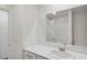 Bright bathroom featuring a white vanity with a large mirror and a shower with white tiles at 816 Sand Camel Ct, North Las Vegas, NV 89081