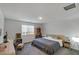 Bright bedroom featuring a cozy bed, bedside table with lamp, and a bookshelf filled with books at 816 Sand Camel Ct, North Las Vegas, NV 89081