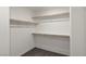 Walk-in closet with white walls and wooden shelves and carpeted floors at 816 Sand Camel Ct, North Las Vegas, NV 89081