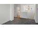 Hallway leading to laundry room, featuring carpeted floors and modern lighting at 816 Sand Camel Ct, North Las Vegas, NV 89081