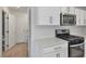 Kitchen boasts stainless steel appliances, and white cabinets, adjacent to powder room at 816 Sand Camel Ct, North Las Vegas, NV 89081