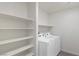 Well-lit laundry room with white appliances and shelving at 816 Sand Camel Ct, North Las Vegas, NV 89081