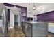 Modern kitchen featuring stainless steel appliances, dark wood floors, and unique purple accent wall at 9000 S Las Vegas Blvd # 2222, Las Vegas, NV 89123